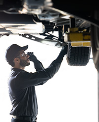 man inspecting tire