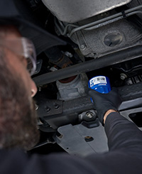 man changing oil filter